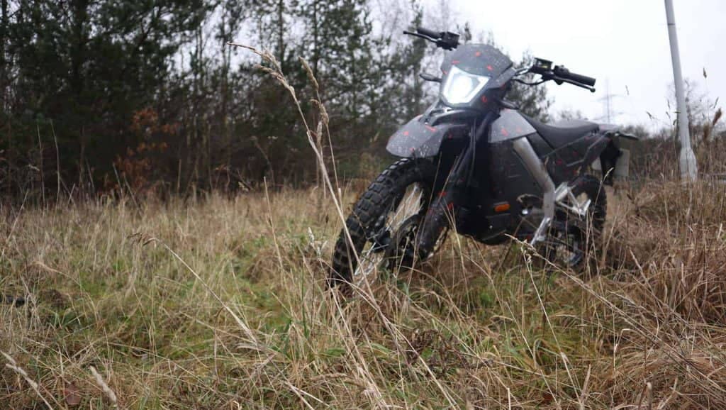 Off-road electric motorcycle in the middle of a field