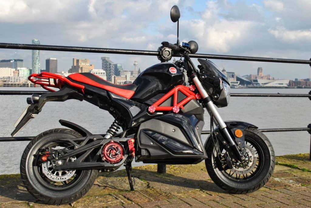 Red and black Ev0 electric motorcycle with Liverpool skyline