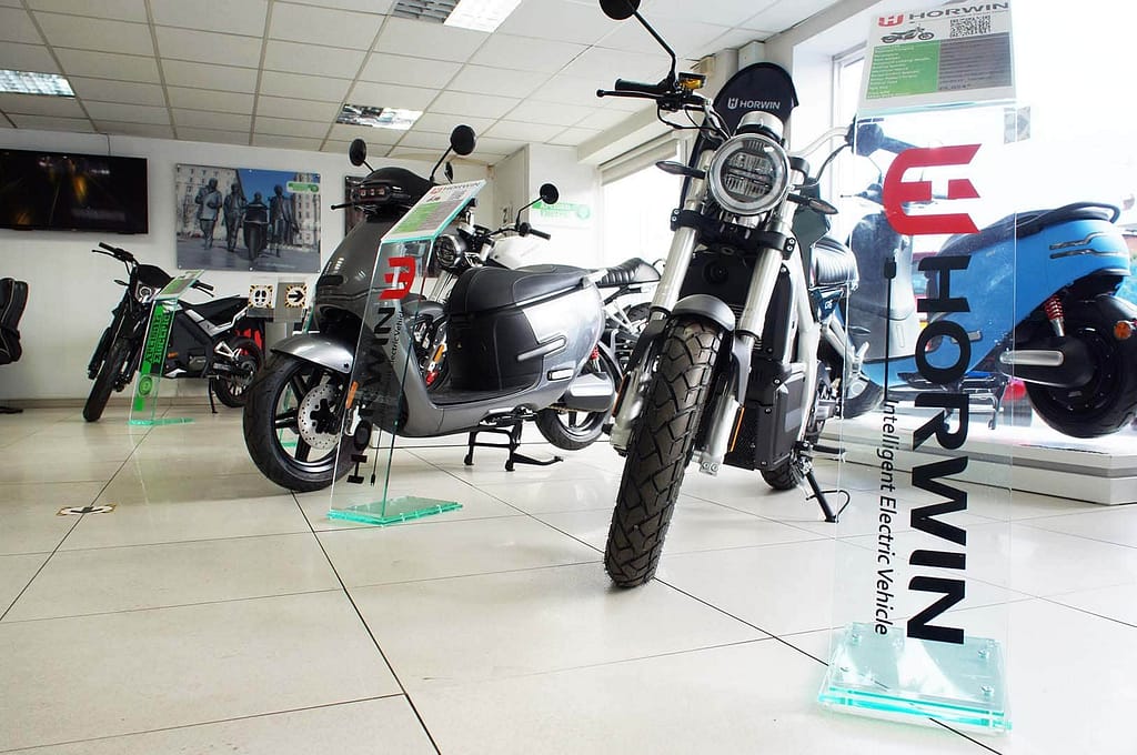 checkpoint cars showroom with electric motorbikes and scooters in it