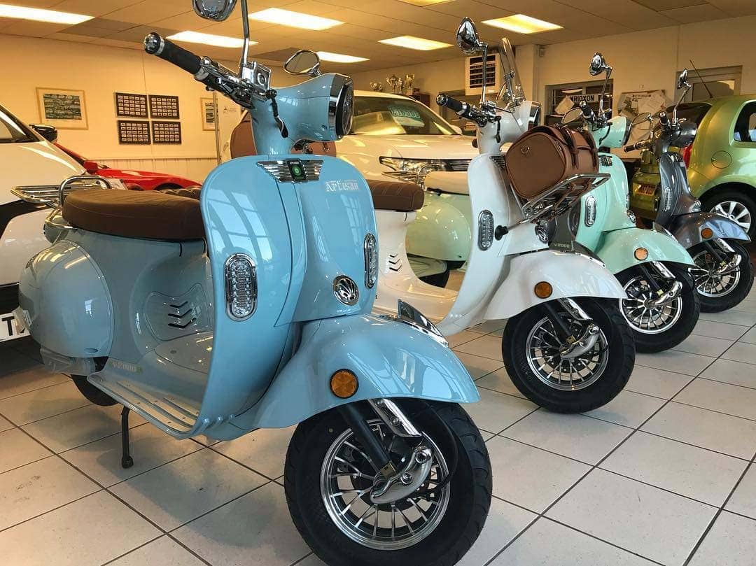 Row of Artisan scooters in a dealership showroom