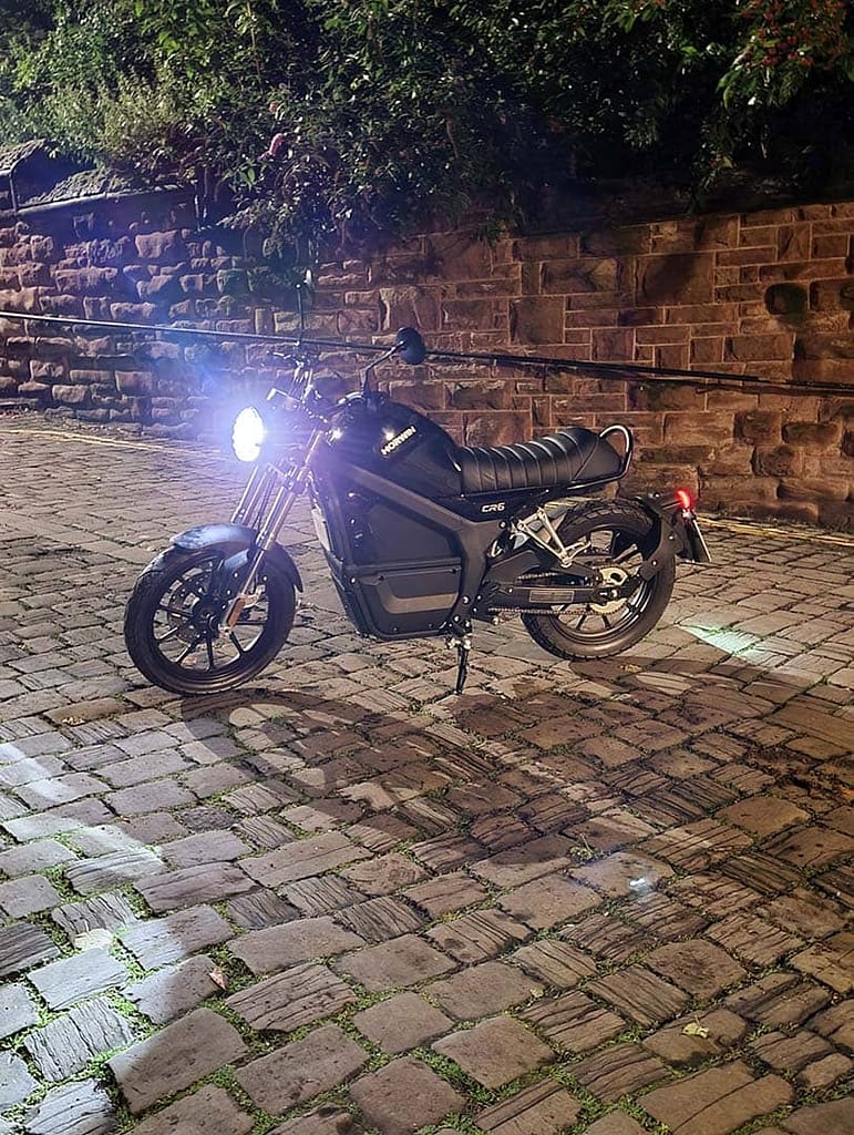 Electric Motorbike on a cobbled street at night