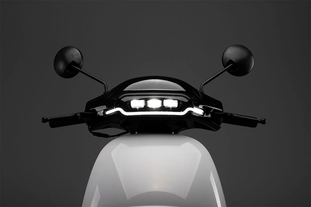 led headlights on the white delivery scooter
