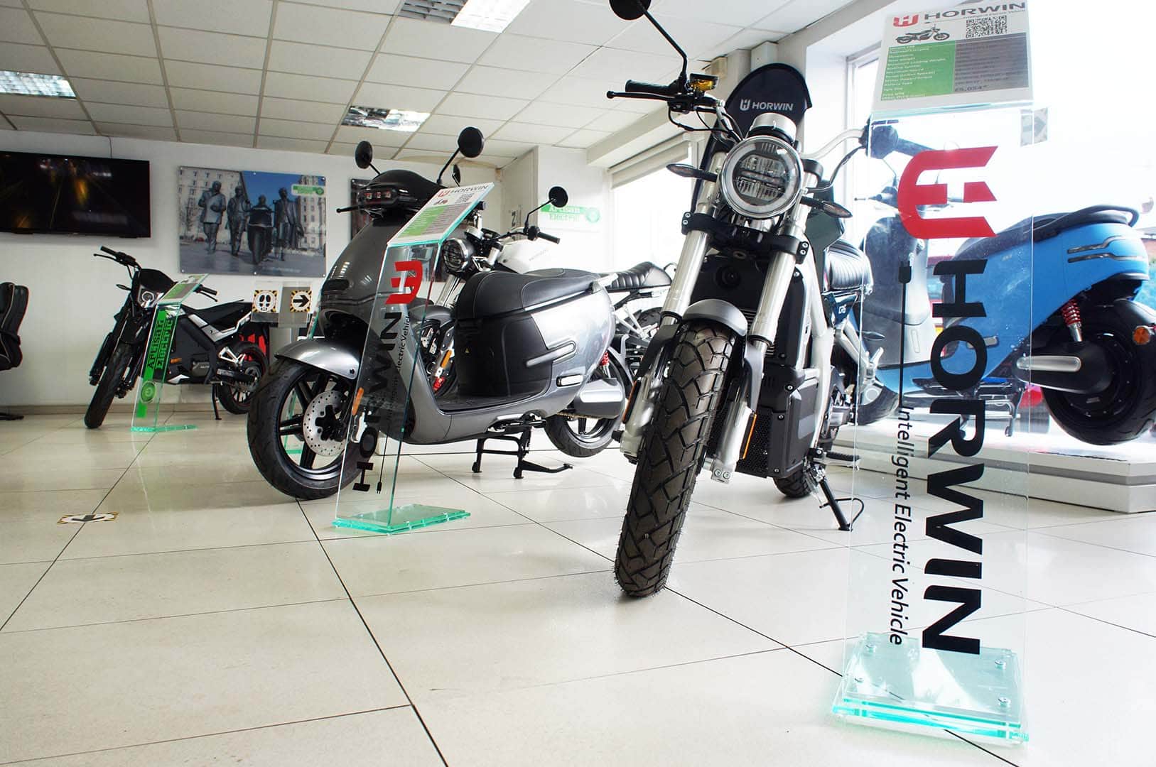 checkpoint cars showroom with electric motorbikes and scooters in it