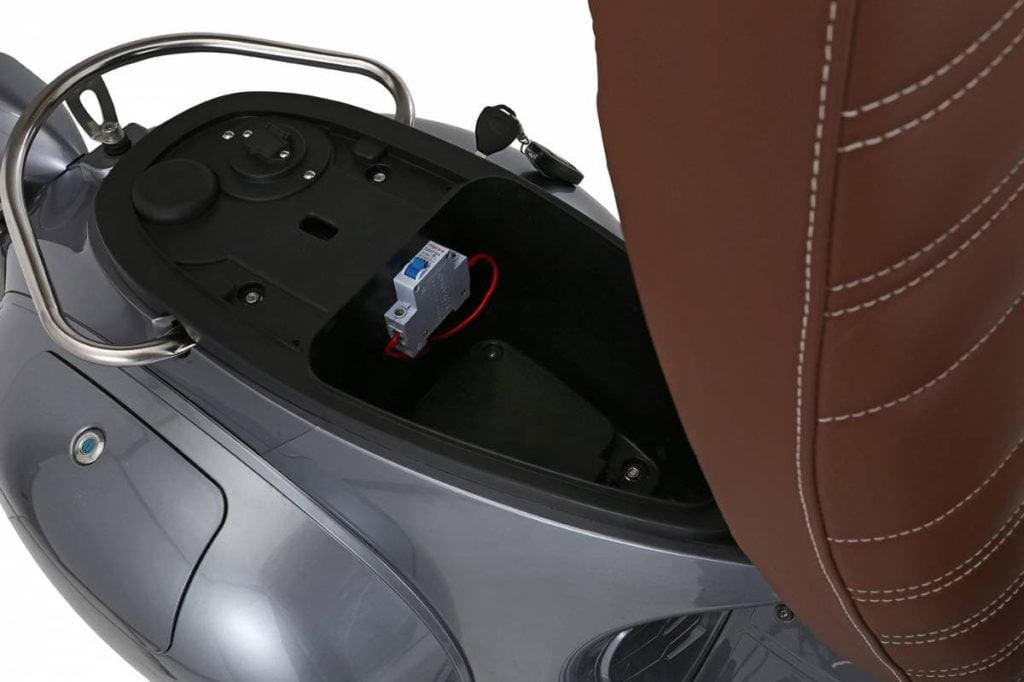 Battery and storage compartment under the open seat lid