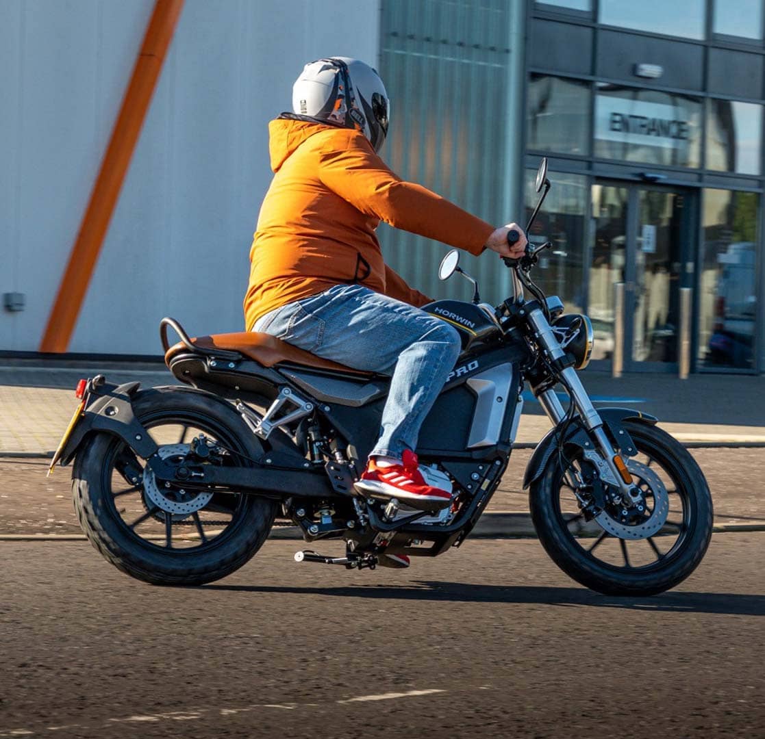 Rider with orange jacket enjoying Horwin CR6 Pro electric motorcycle