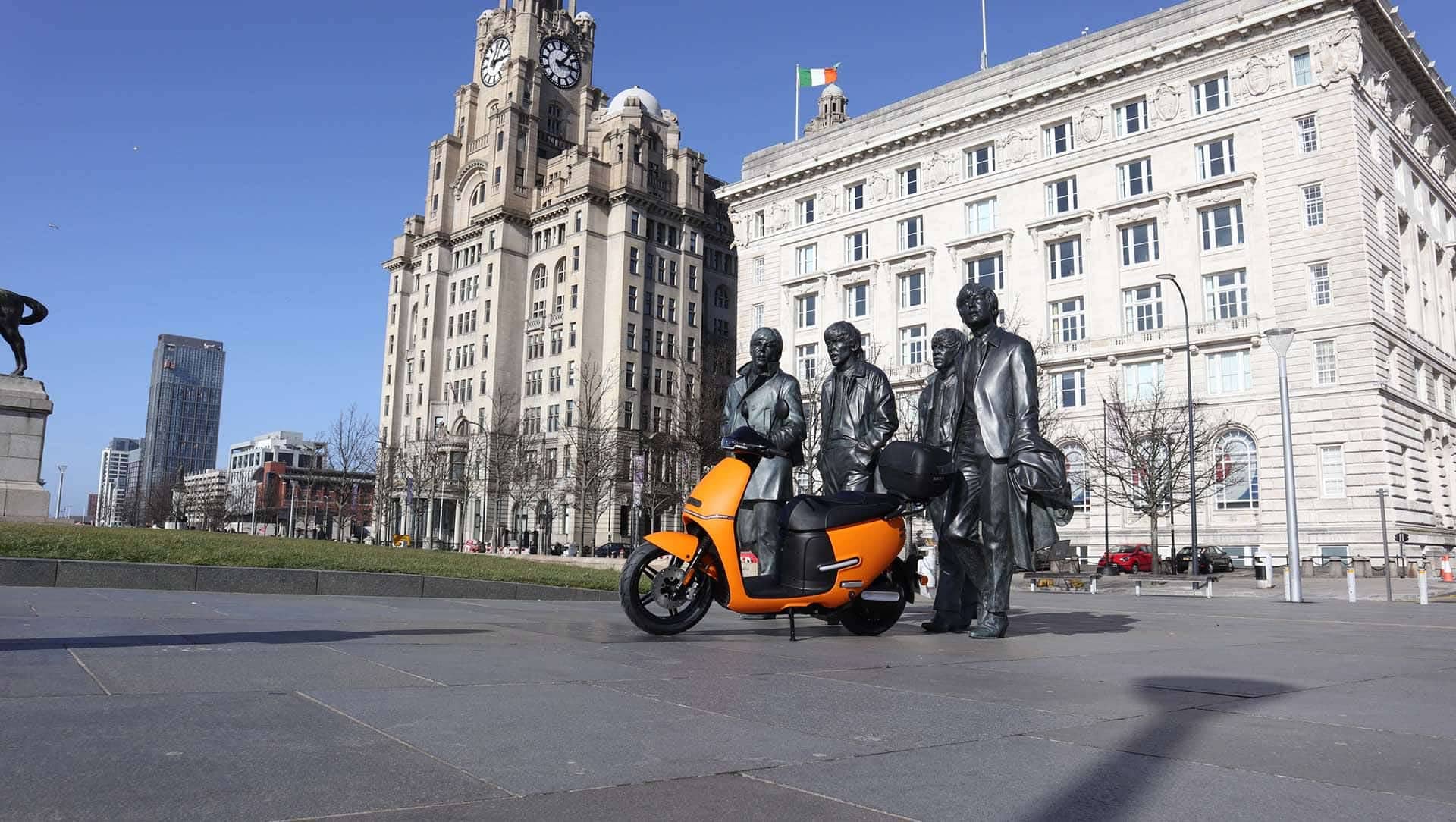 electric moped with beatles statue in liverpool