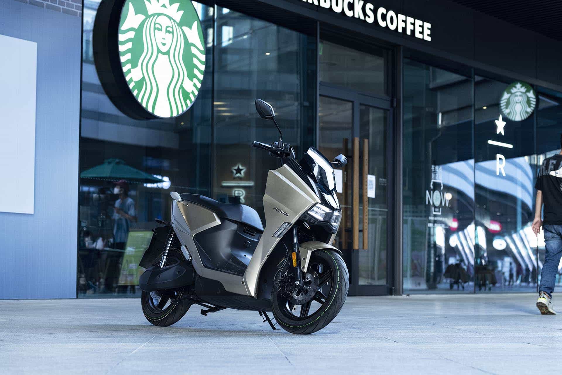 SK3 electric scooter outside Starbucks coffee shop